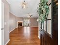 Inviting living room featuring hardwood floors, a cozy fireplace, and French doors offering a welcoming space at 705 Trickum Valley Dr, Woodstock, GA 30188