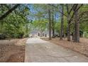 Beautiful home surrounded by mature trees and a long driveway at 110 Emerald Dr, Mcdonough, GA 30253