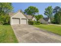 Ranch-style home featuring a two-car garage and a long driveway at 1220 Paddocks Way, Powder Springs, GA 30127