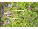 An aerial view shows the home nestled on a large, private lot surrounded by mature trees at 128 Partridge Rdg, Woodstock, GA 30188