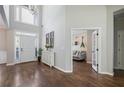 Bright foyer with hardwood floors, a high ceiling, and access to the living room at 4232 Millside Se Walk, Smyrna, GA 30080