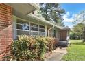 A charming brick home with lush greenery and a quaint porch entrance, creating a cozy curb appeal at 3137 Ardley Sw Rd, Atlanta, GA 30311