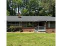 Charming brick home with a well-maintained lawn and mature trees at 3137 Ardley Sw Rd, Atlanta, GA 30311