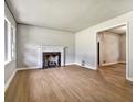 Bright living room featuring hardwood floors, a classic fireplace, and ample natural light at 3137 Ardley Sw Rd, Atlanta, GA 30311