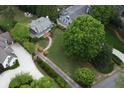 Aerial view of a home and surrounding manicured lawn, mature trees, and gardens at 4220 Club Ne Dr, Atlanta, GA 30319