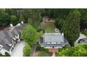 Stunning aerial view of an estate home with lush landscaping and mature trees at 4220 Club Ne Dr, Atlanta, GA 30319