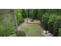 A spacious backyard with a stone patio features a seating area perfect for relaxing or entertaining guests at 4220 Club Ne Dr, Atlanta, GA 30319