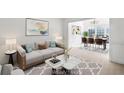 Bright living room with modern decor and an open floor plan adjacent to the dining area at 1268 Windsor Glen Dr, Douglasville, GA 30134