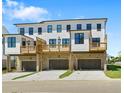 Rear exterior of townhomes with garages, decks, and modern architectural details at 2852 Evanshire Ave # 114, Duluth, GA 30096