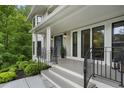 Charming front porch with black railings and a welcoming entrance at 660 Willow Knoll Se Dr, Marietta, GA 30067