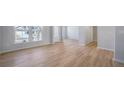 Bright open-concept living space featuring hardwood floors and large windows at 108 Aj Welch Jr Way, Mcdonough, GA 30252