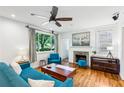 Comfortable living room with a fireplace, hardwood floors, and a large window overlooking the yard at 1248 Conway Rd, Decatur, GA 30030