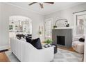 Inviting living room featuring a brick fireplace, hardwood floors, and modern furniture at 1575 Linda Sw Way, Atlanta, GA 30310