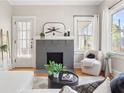 Inviting living room featuring a brick fireplace, hardwood floors, and modern furniture at 1575 Linda Sw Way, Atlanta, GA 30310