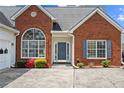 Welcoming brick home featuring a large front window, well-maintained garden, and classic design at 1284 Charter Club Ct, Lawrenceville, GA 30043