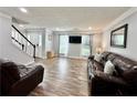 Spacious living room offers wood-look flooring, natural light, and modern finishes, creating a welcoming space at 5223 Hollyfield Dr, Stone Mountain, GA 30088