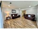 Inviting living room features wood-look flooring, neutral walls, and comfortable seating, perfect for relaxation at 5223 Hollyfield Dr, Stone Mountain, GA 30088