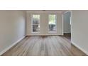 Inviting room showcasing new flooring, fresh paint, and bright windows at 1206 Kern Cv, Mcdonough, GA 30253