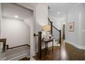 Hallway featuring a staircase, dark hardwood floors, white walls, and dark wood trim and railings at 126 Abbington River Ln, Atlanta, GA 30339