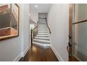Elegant foyer featuring hardwood floors, a staircase, and stylish interior design at 126 Abbington River Ln, Atlanta, GA 30339