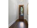 Inviting foyer with hardwood floors, a glass paneled front door, and neutral wall colors at 126 Abbington River Ln, Atlanta, GA 30339