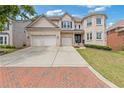 Attractive brick home with a spacious driveway, a two-car garage, and a neatly maintained front yard at 2311 Norbury Se Cv, Smyrna, GA 30080
