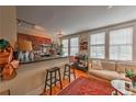 Open-concept kitchen and living room featuring hardwood floors, bright windows, and a comfortable seating area with stylish rug at 733 Frederica Ne St # 2, Atlanta, GA 30306
