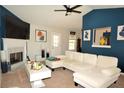 Comfortable living room with a fireplace, plenty of seating, and lots of natural light at 2176 Cold Springs Cir, Lithonia, GA 30058
