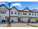 Attractive townhomes with white exteriors, garages, brick driveways, and manicured landscaping, ideal for modern living at 4142 Spring Valley Cir # 65, Tucker, GA 30084