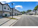 A view of the homes in a community with a well-maintained street and sidewalks at 4142 Spring Valley Cir # 65, Tucker, GA 30084