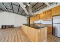 Bright, open kitchen with wood cabinets, stainless steel appliances, and a large island with a black countertop at 120 Ralph Mcgill Ne Blvd # 1304 & 1305, Atlanta, GA 30308