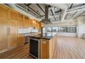Bright kitchen with wooden cabinets, black countertops, stainless steel appliances, and a large island at 120 Ralph Mcgill Ne Blvd # 1304 & 1305, Atlanta, GA 30308