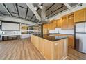 Open kitchen with a large island, wooden cabinets, stainless steel appliances, and modern design at 120 Ralph Mcgill Ne Blvd # 1304 & 1305, Atlanta, GA 30308
