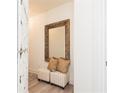 Cozy entryway featuring a comfortable bench seat, stylish decorative mirror, and neutral color palette at 1567 Aiden Way # 34, Conyers, GA 30013