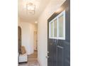 Inviting entryway with a bench seat, decorative mirror, and contemporary lighting fixture to welcome visitors at 1567 Aiden Way # 34, Conyers, GA 30013