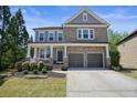 Charming two-story home with stone and siding, and a welcoming front porch at 526 Lost Creek Dr, Woodstock, GA 30188