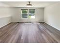 The space features light-colored walls, modern ceiling fan, and windows looking out onto the yard at 5790 Ivywood Dr, Lithonia, GA 30038