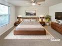 Comfortable bedroom with a ceiling fan, plush rug, and coordinated furniture set for relaxation at 5790 Ivywood Dr, Lithonia, GA 30038