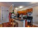 Functional kitchen with breakfast bar, wood cabinets, and modern appliances at 741 Frederica Ne St # 8, Atlanta, GA 30306