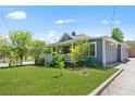 Attractive home with a covered porch, green lawn, mature trees, and a driveway, presenting a desirable exterior at 873 United Se Ave, Atlanta, GA 30312