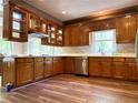 Well-lit kitchen with custom wood cabinetry, white countertops, and modern stainless steel appliances at 225 Austin Oaks Se Dr, Ellenwood, GA 30294