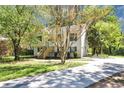Inviting two-story home with a spacious driveway, surrounded by mature trees and a lush green lawn at 1327 Laura Ln, Austell, GA 30168