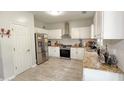 Bright kitchen features stainless steel appliances, granite countertops, white cabinets, and tile flooring at 2144 Beacon Crest Dr, Buford, GA 30519