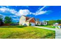 Well-kept suburban home featuring lush landscaping and a long driveway at 2144 Beacon Crest Drive, Buford, GA 30519