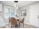 Bright dining area featuring a modern light fixture, a round table with seating for four, and a door at 2198 Star Mist Sw Dr, Atlanta, GA 30311