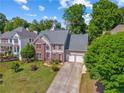 Charming two-story home featuring a well-manicured lawn and a spacious two-car garage at 2325 Walnut Grove Way, Suwanee, GA 30024