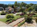 View of the neighborhood with well-maintained landscaping, sidewalks, and colorful flower beds in the front yard at 2325 Walnut Grove Way, Suwanee, GA 30024