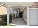 Inviting front porch with white columns and elegant hanging lanterns leads to the black front door at 3709 Baxley Ridge Dr, Suwanee, GA 30024