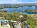 Breathtaking aerial view of the home nestled among lush trees with a stunning lake backdrop at 7665 Golden Sands Dr, Cumming, GA 30041