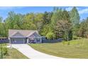 Charming single-Gathering home with a two-car garage and inviting front lawn at 12 Little Creek Manor Dr, Dallas, GA 30157